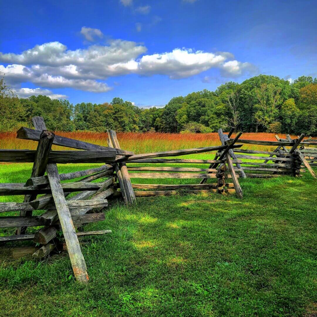 A field with some wooden fences and grass