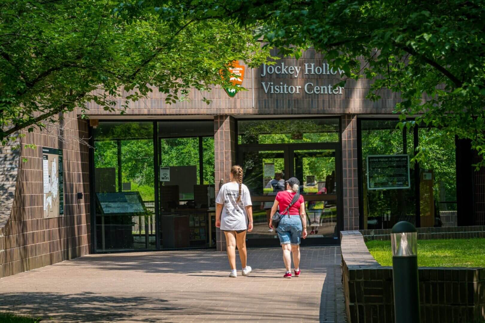 People walking towards Jockey Hollow Visitor Center.